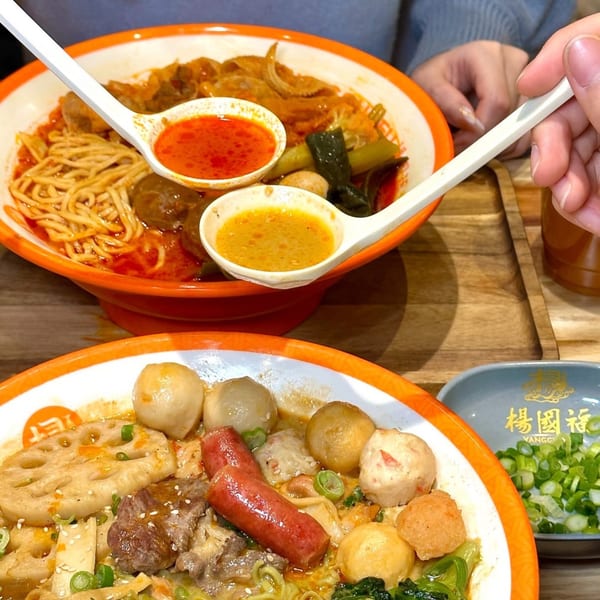 Two bowls of YGF Malatang, one with noodles and tripe, the other with lotus root and sausages.